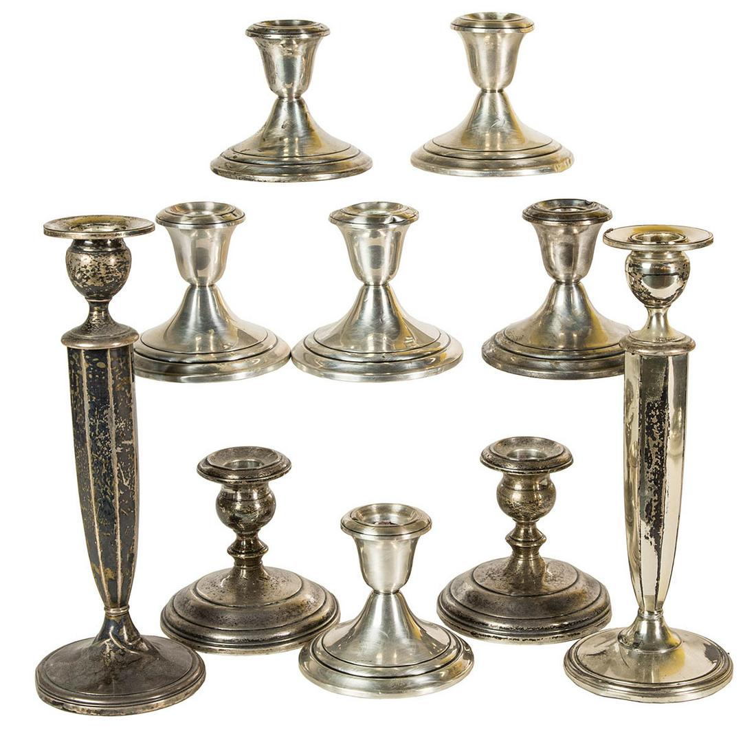 STERLING SILVER CANDLESTICKSEight sterling silver: STERLING SILVER CANDLESTICKSEight sterling silver candlesticks, 3 1/2" h; and two sterling candlesticks, weighted, 91/2" h.