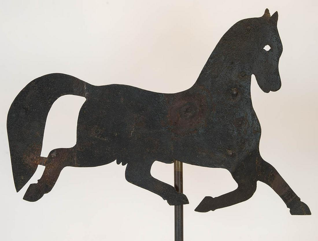 EARLY SHEET IRON WEATHERVANEWeathervane of a stallion,: EARLY SHEET IRON WEATHERVANEWeathervane of a stallion, dark surface weathered with some rust spots, 18" h, 27" l.