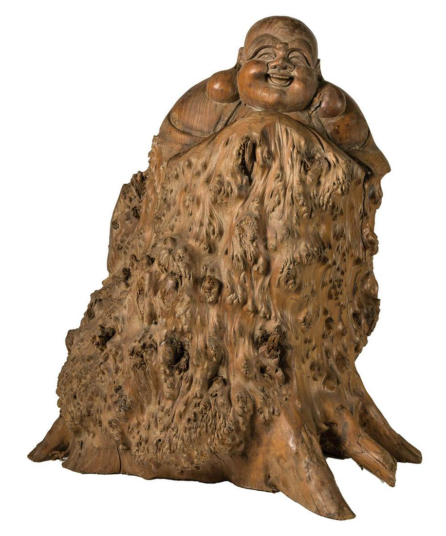 CHINESE SMILING BUDDHACarved from a large burl with: CHINESE SMILING BUDDHACarved from a large burl with root formation at base, 20" h, 19" w, 16" d.