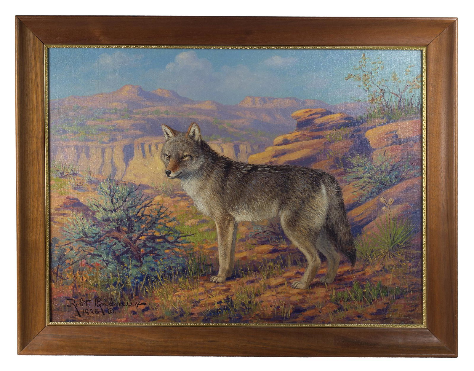 PAINTING BY ROBERT LINDNEUXOil on canvas, "Coyote" in a: PAINTING BY ROBERT LINDNEUXOil on canvas, "Coyote" in a western mountain landscape, signed l.l. "Robt. Lindneux, 1928" (American, 1871-1970), back stretcher inscribed "Coyote, $325.", carved wood fram