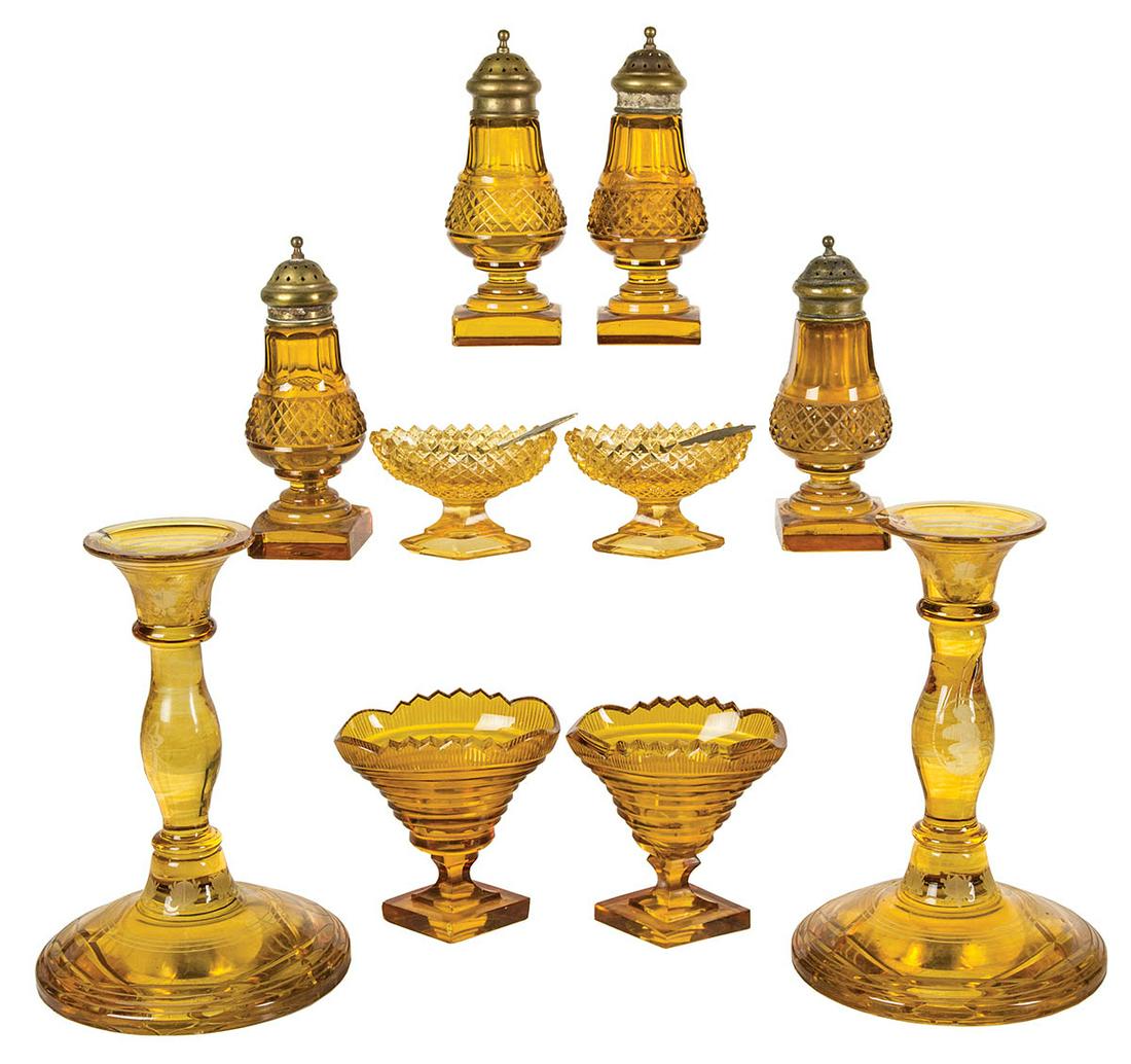 TEN PIECES OF FLINT AND PRESSED GLASS19th c. flint and: TEN PIECES OF FLINT AND PRESSED GLASS19th c. flint and pressed amber colored glass, including candlesticks, 7 1/2" h, four salt and pepper shakers with brass tops, four master salts with diamond shape