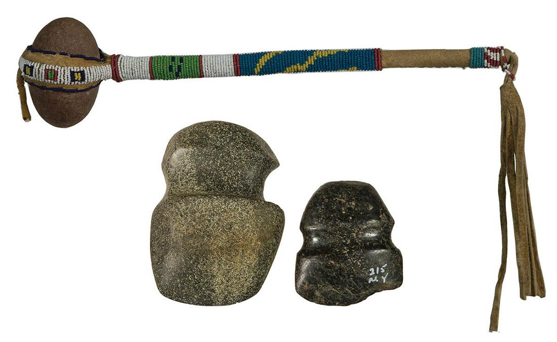 STONE AXE HEADS, AND SKULLCRACKERPolished black stone: STONE AXE HEADS, AND SKULLCRACKERPolished black stone axe, (very old chip out of lower edge), marked "215 N.Y.", 4" l; "Archaic Axe Indiana", flat on one side, finely grooved, 6 1/2" l; Skullcracker,