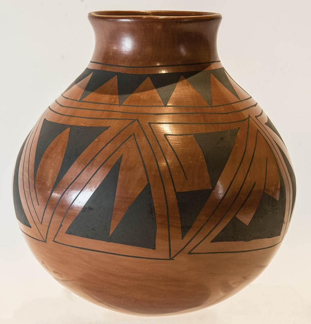 PUEBLO POTTERY OLLAFlared rim, red glazed pot with: PUEBLO POTTERY OLLAFlared rim, red glazed pot with black geometric decoration, signed "Lad Ortiz", 11" h.