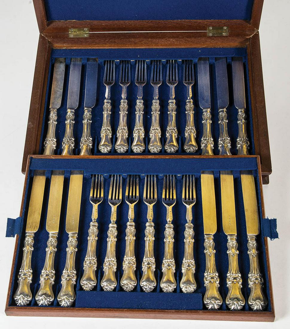 BOXED SET OF KNIVES AND FORKSVery fine mahogany boxed: BOXED SET OF KNIVES AND FORKSVery fine mahogany boxed set of 12 knives and forks, hallmarked "W.S.", in blue felt interior.