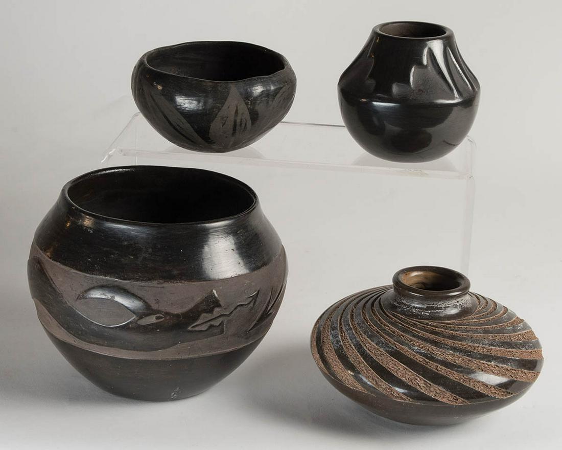 FOUR PUEBLO BLACK ON BLACK POTTERY JARSLarger jar with: FOUR PUEBLO BLACK ON BLACK POTTERY JARSLarger jar with raised water serpent, signed "Mary Cata", 6" h, 7" dia; Intricate design jar with indented hoof prints, and white and black bands, B-CH "Berta Cr