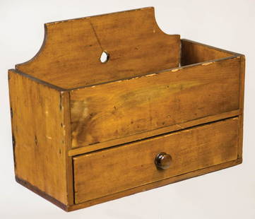 HANGING UTILITY BOXPoplar, original varnish finish, shaped back with hole for hanging on a small: HANGING UTILITY BOXPoplar, original varnish finish, shaped back with hole for hanging on a small peg, 3 1/2" deep well, single dovetailed drawer with small turned walnut pull, symmetrically "T" head