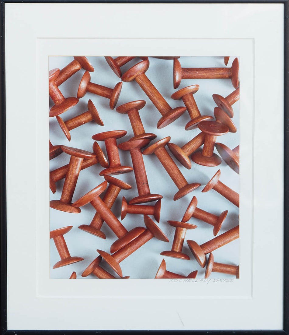 PHOTOGRAPH OF A SHAKER SPOOL COLLECTION Red on white background, signed l.r. "Rocheleau/Sprigg", (1 of 1)