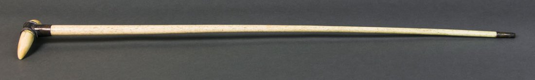 Whalebone cane, 34" l: 19TH C. SAILOR CARVED WHALEBONE CANE Silver mounted "T" shaped top, securing a 5" whales tooth, 1 1/2" brass tipped ferrule at end, 34" l, (ex. Dr. Oscar and Lois Hollander collection, Falmouth, MA).