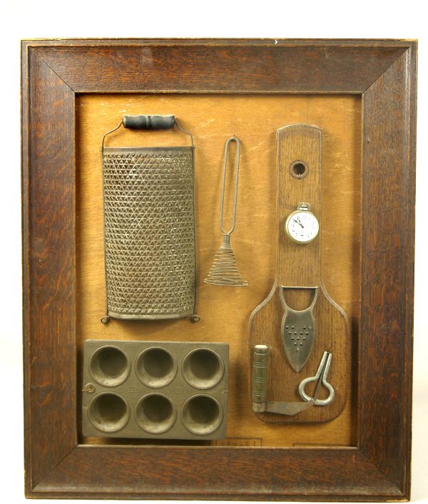 Early 20th c. framed kitchen collage, with graters: Early 20th c. framed kitchen collage, with graters, muffin tin, whisk, paring knife, cutting board, etc., in an oak frame, 25 1/2" x 21 1/2" overall.