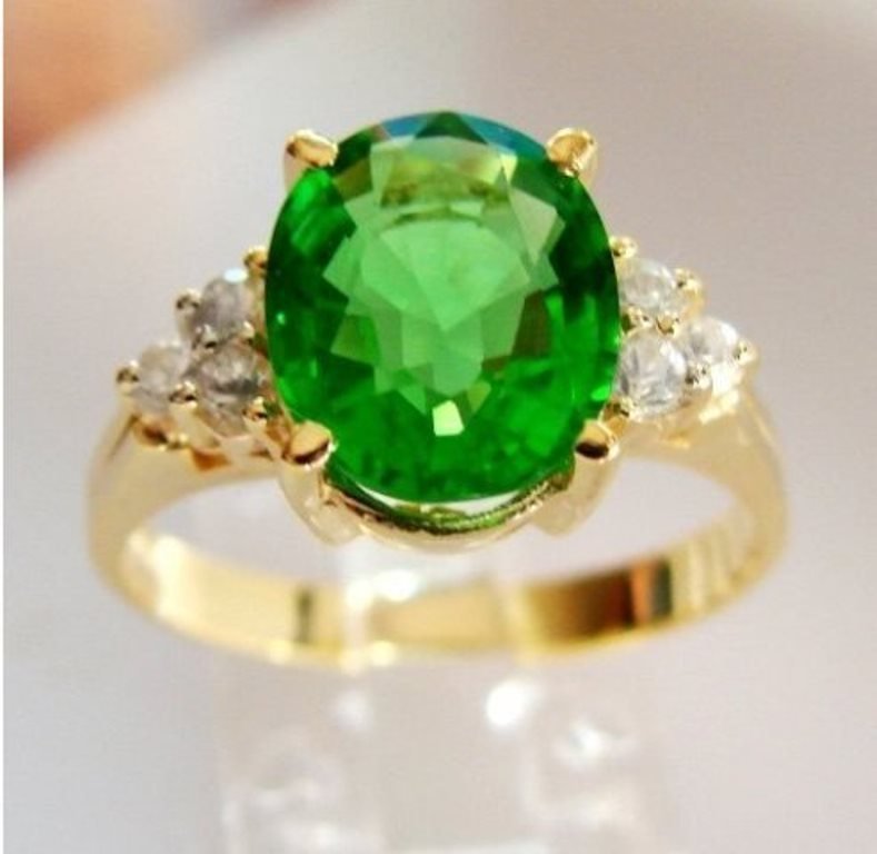 Green Tsavorite Ring: 2.15Ct Diamond: .30Ct 14kY/g: Gem Type: Natural Tsavorite/White Sapphire Item: Ring Quantity: 1 Diamond: .30 carat round (Clarity: VS1, Color: F) Tsavorite: 2.15 carat oval shape (Clarity VS1, Color: Green, Treatment: None, Origin