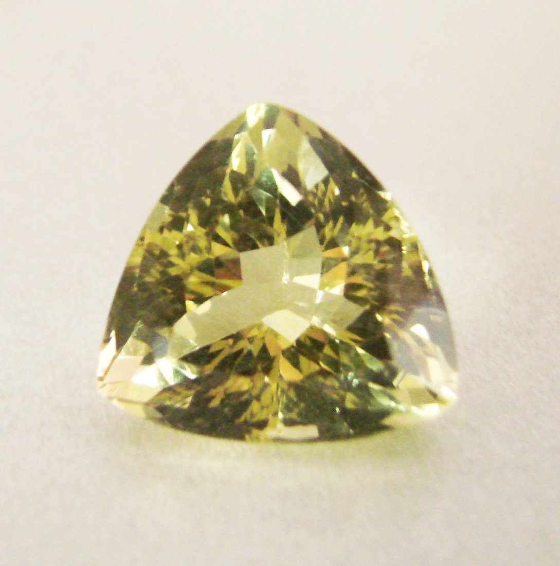Natural Lemon Topaz Trillion Shape 16.73Ct: Gem Type: Natural Lemon Topaz Qty: 1 Weight: 16.73 Carat Measurement: 17.2x16.5x11.5 mm Shape: Trillion Cut: Facet Cut Clarity: VS Color: Light Yellow Origin: Brazil