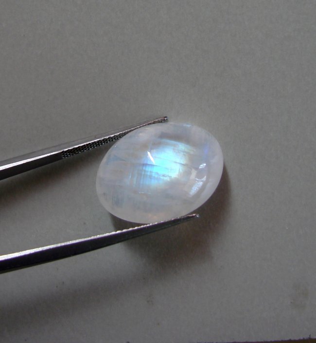 Blue White Rainbow Moonstone Oval 7.29Ct: Gem: Natural Moonstone Qty: 1 Weight: 7.29 Carat Oval Shape Cut: Cabochon Measurement: 13.8 x 10 x 6.5 mm Clarity: Transparent Color: Blue White Rainbow Treatment: None Origin: Sri Lanka (Ceylon