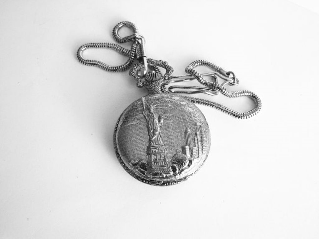 Pocket Watch 'L' Luis Cardini 18k W/g Overlay: Pocket Watch Luis Cardini Quartz Japan Movement,18k White Gold Overlay Carved: Lady Liberty and Leaf Design on the back side Size:1.3/4 x 1.3/4 mm Come With Chain 14.5"-Run By Battery Estimated Value