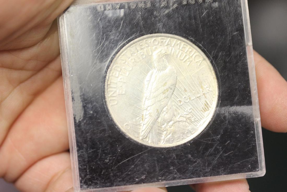 A 1923 Peace Silver Dollar: as shown on photos