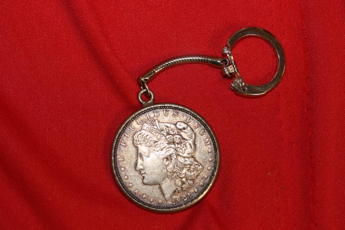 A 1921 Morgan Silver Dollar: inside a keychain - most likely custom made