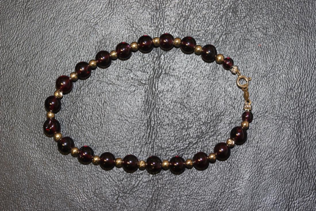 A Small 14Kt Gold and Gemstone Bracelet: for a small wrist or a child bracelet - some dents on the few of the gold beads