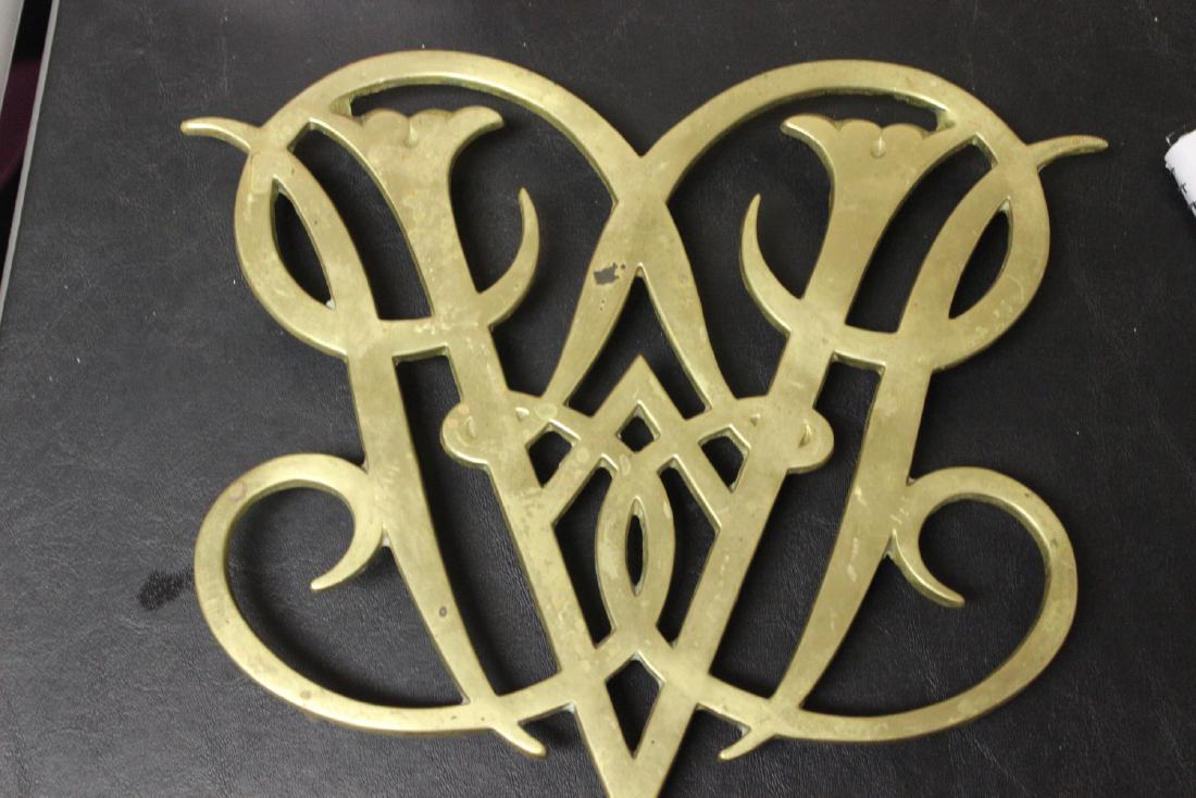 A Brass Williamsburg, Queen Ann Cypher Trivet: approximately 10 1/4" across