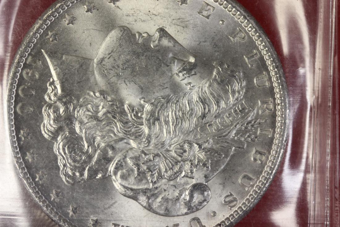 A 1900 P Morgan Silver Dollar: An old grading from IGA - MS 64/65