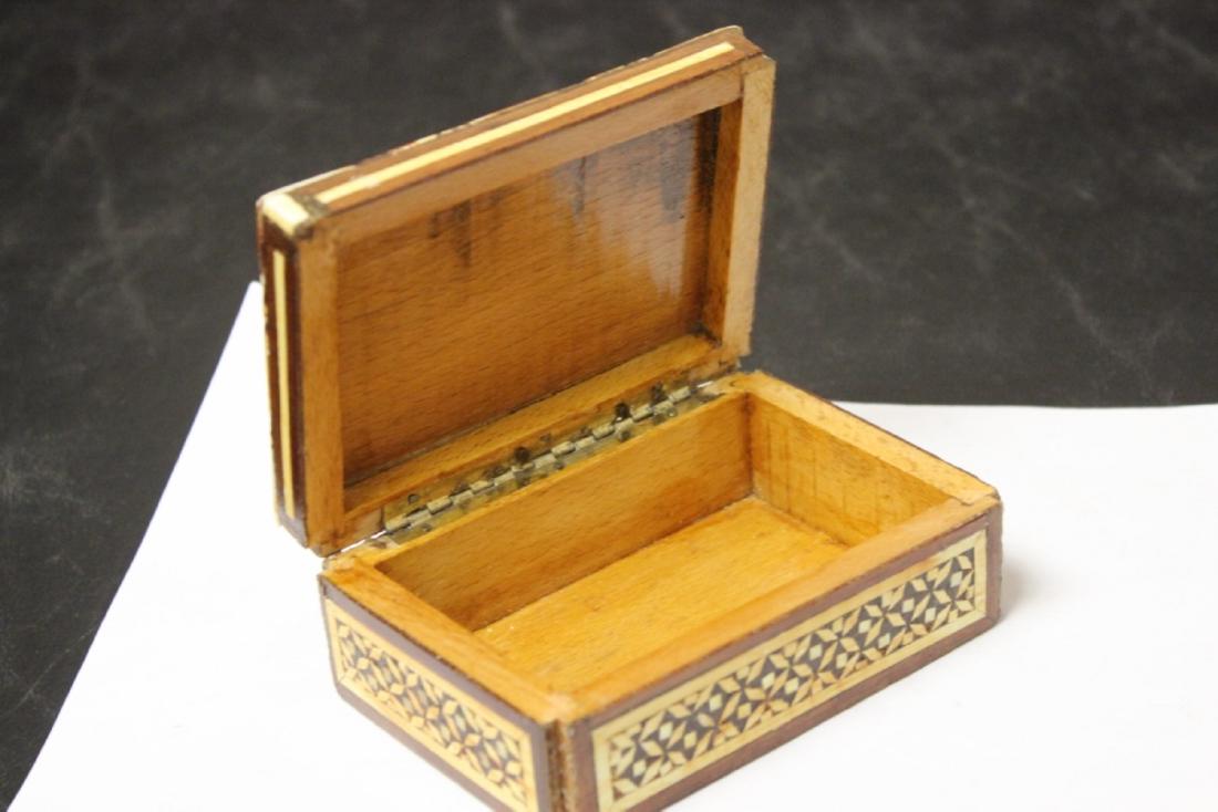 An Inlaid Wooden Box: 4 3/4" x 3 1/4" x 1 3/4" - please note: losses on the corner