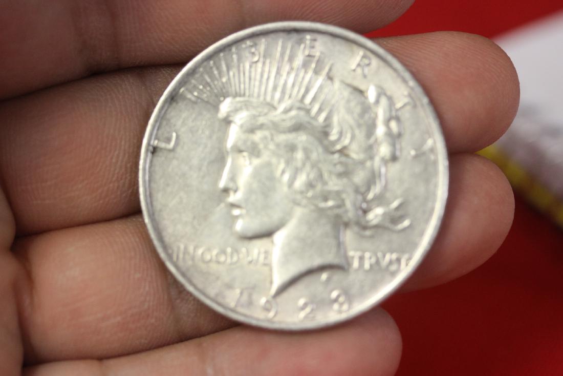 A 1923 Peace Silver Dollar: as shown