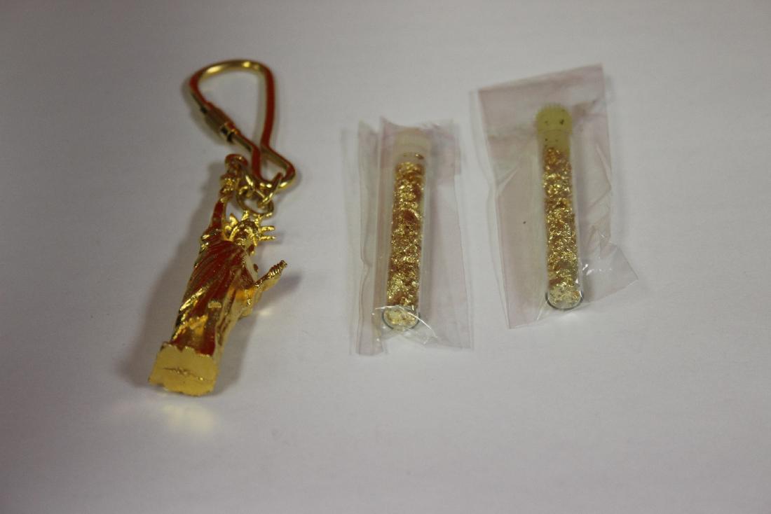 A Statue of Liberty Keychain and Two Tubes of Gold: as shown