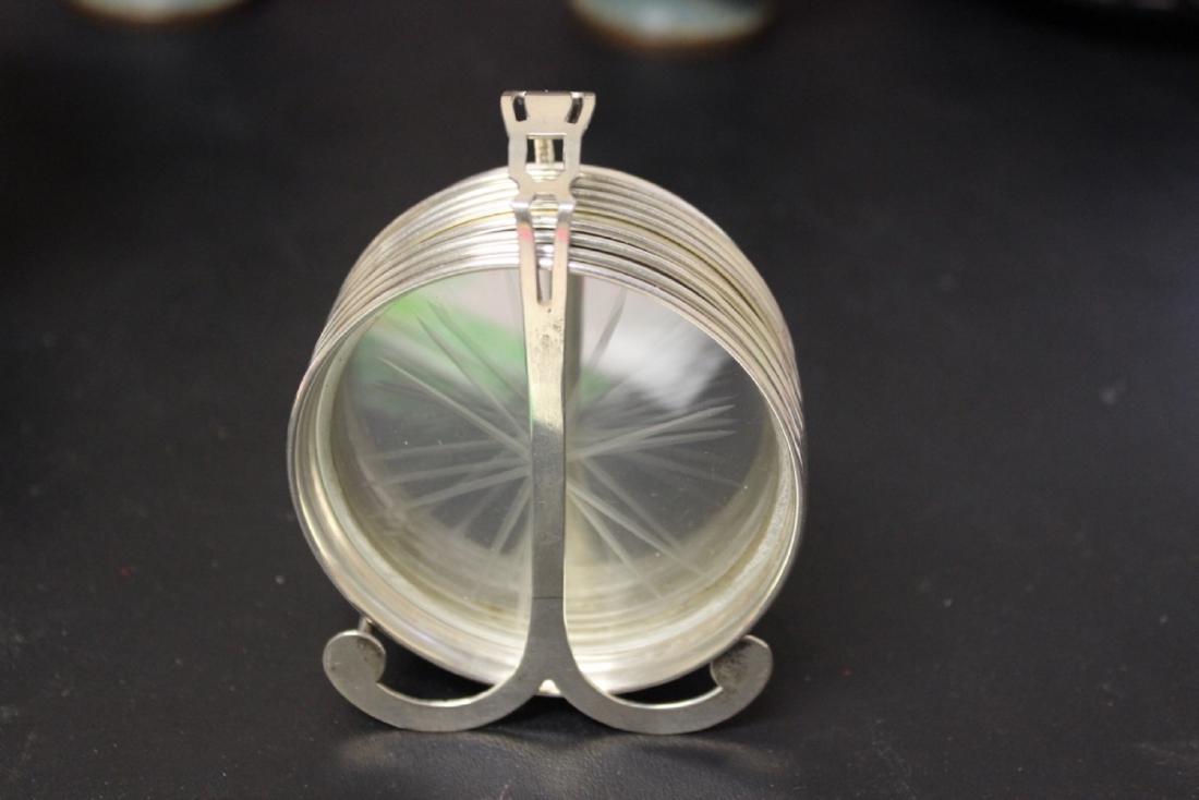 A Set of Sterling Coasters (8) and a Sterling Holder: Marked sterling - coasters= 3 1/8 inches in diameter