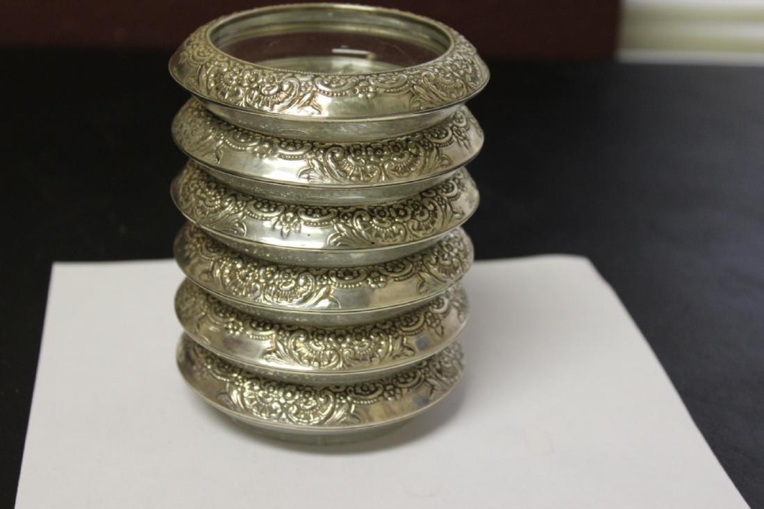 A Set of Six Sterling Coasters: Marked sterling and very ornate - 4 inches in diameter each