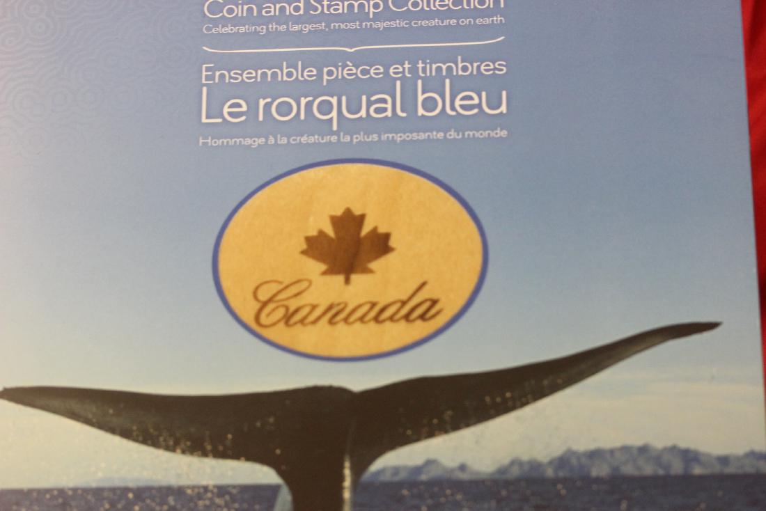 The Blue Whale Coin and Stamp Collection: from Canada - still sealed in a plastic wrap - sterling silver coin and two $10.00 Canada stamp - one stamp has been cancelled