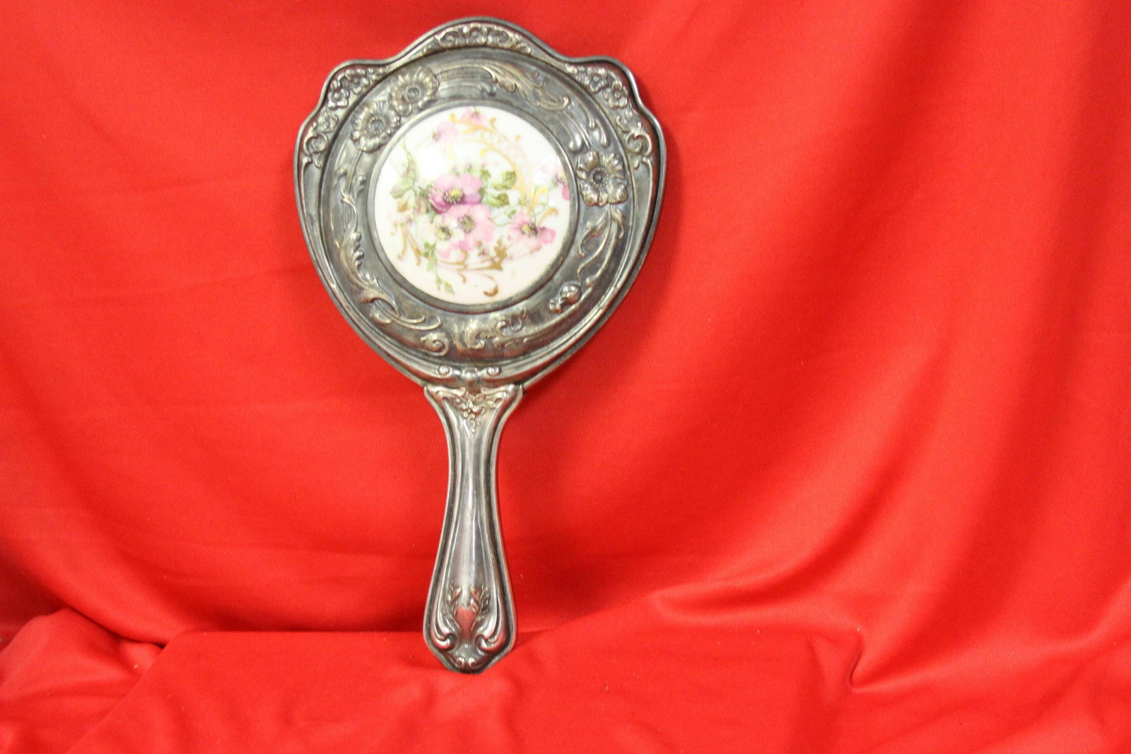 An Ornate Mirror: Silverplated and porcelain - 10 1/2" long