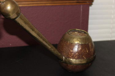 An Oriental Coconut and Brass Dipper