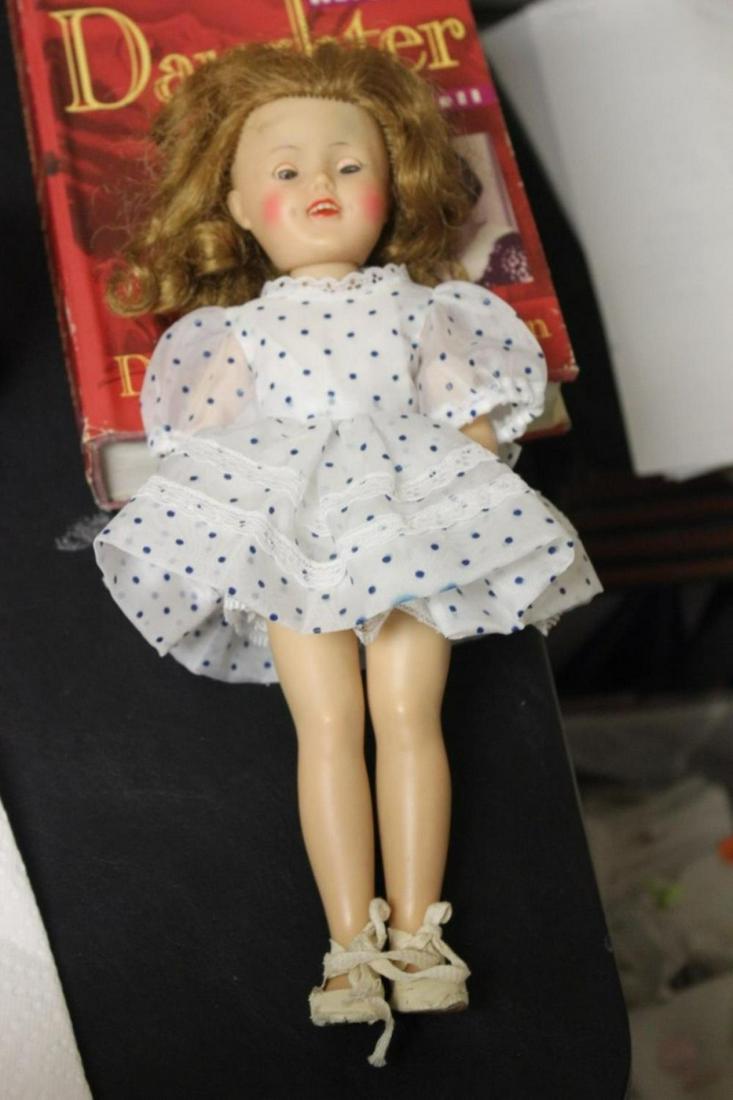 A Shirley Temple Doll by Ideal: 12" tall - needs a doll stand in order to stand without holding