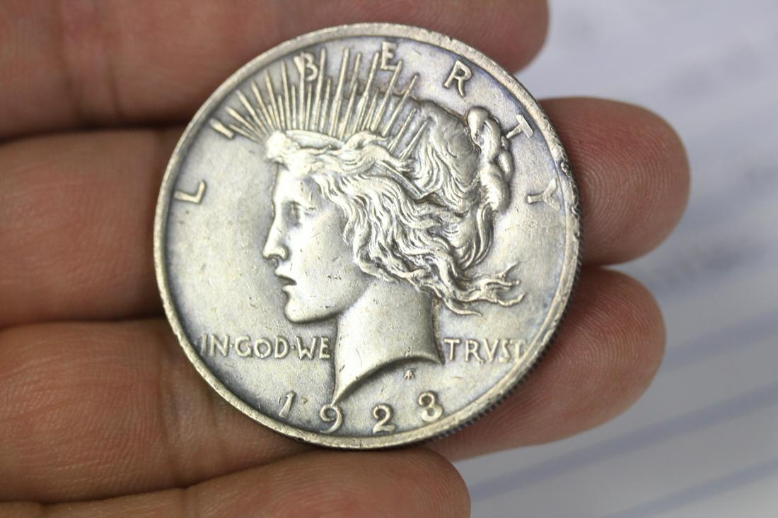A 1923 Peace Silver Dollar: as shown