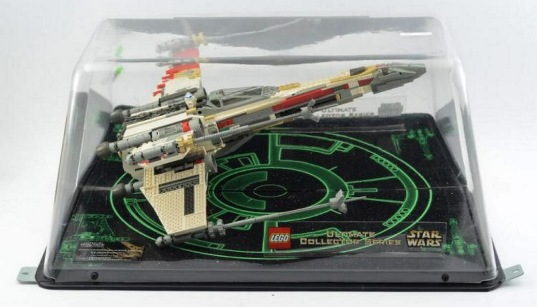 Star Wars X-Wing Fighter Lego Display: Store display for Lego Ultimate Collector Series. Model is cut in half for display, and mirrored background gives illusion of floating full assembled figure. Measures 12" x 27 1/2" x 13 3/4" - this