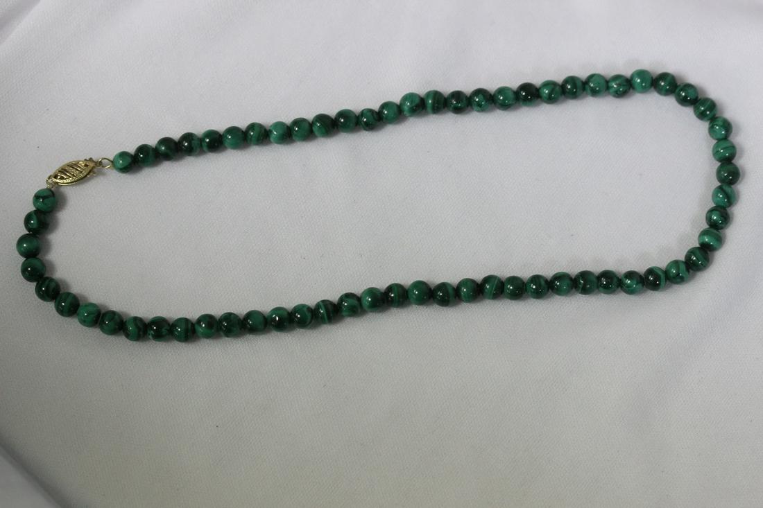 A 14 Karat Gold and Malachite Necklace: 7 1/4" long when clapsed