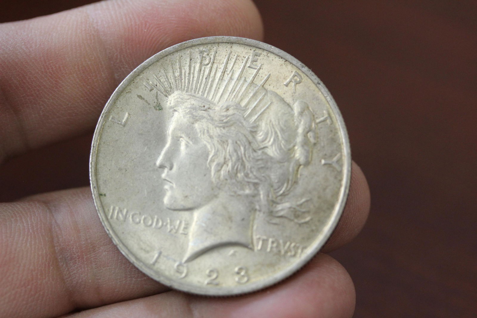 A 1923 Peace Silver Dollar: as shown