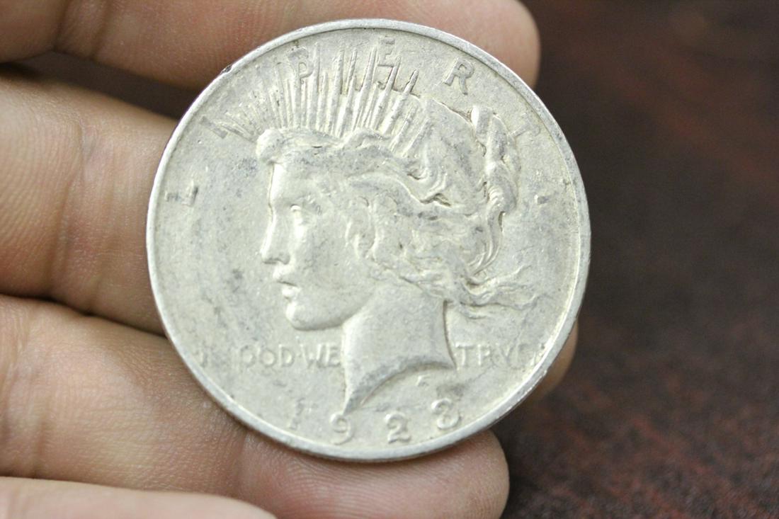 A 1923-D Peace Silver Dollar: as shown