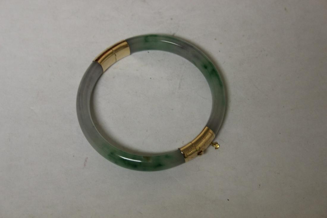 A 14Kt Gold Jade Bangle Bracelet: Apple Green Jadeite - very nice - inside diameter= 2 1/4"