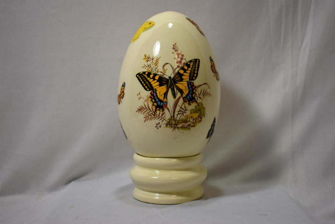 A Signed Ceramic Egg with Stand: overall= 9" tall