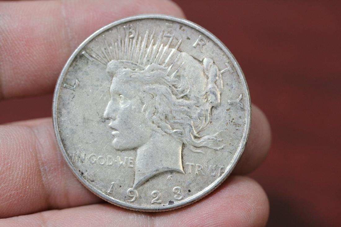 A 1923-D Peace Silver Dollar: as shown