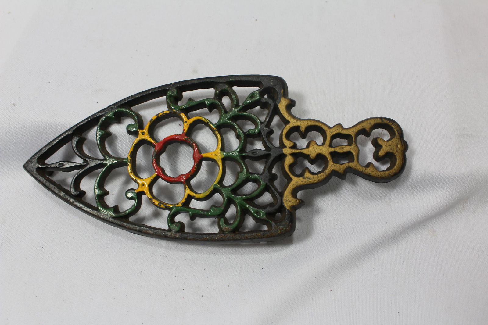 A Cast Iron Trivet: 8" long , including the handle