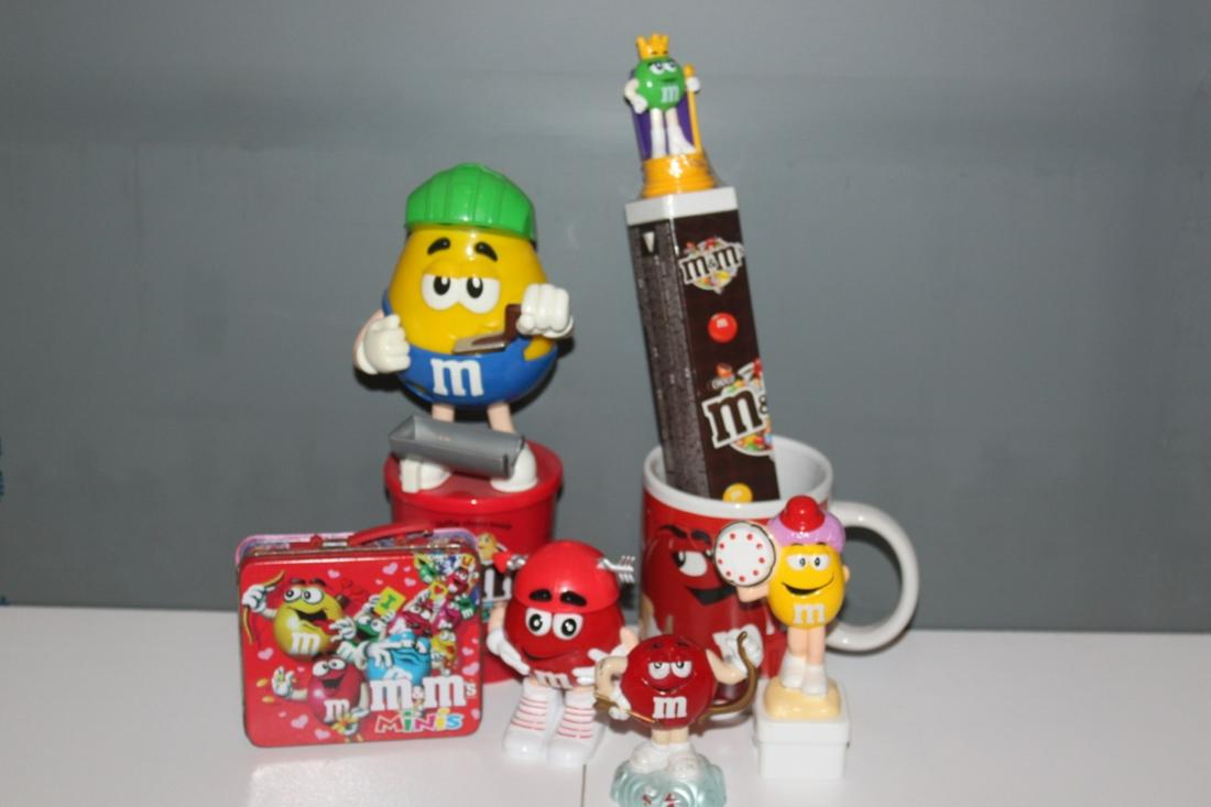 Large Lot of Assorted M&M Candy Collectibles - Yellow,: Red Coffee Cup, Tin Box, unopened box of candy, and three additional dispensers as shown on photos