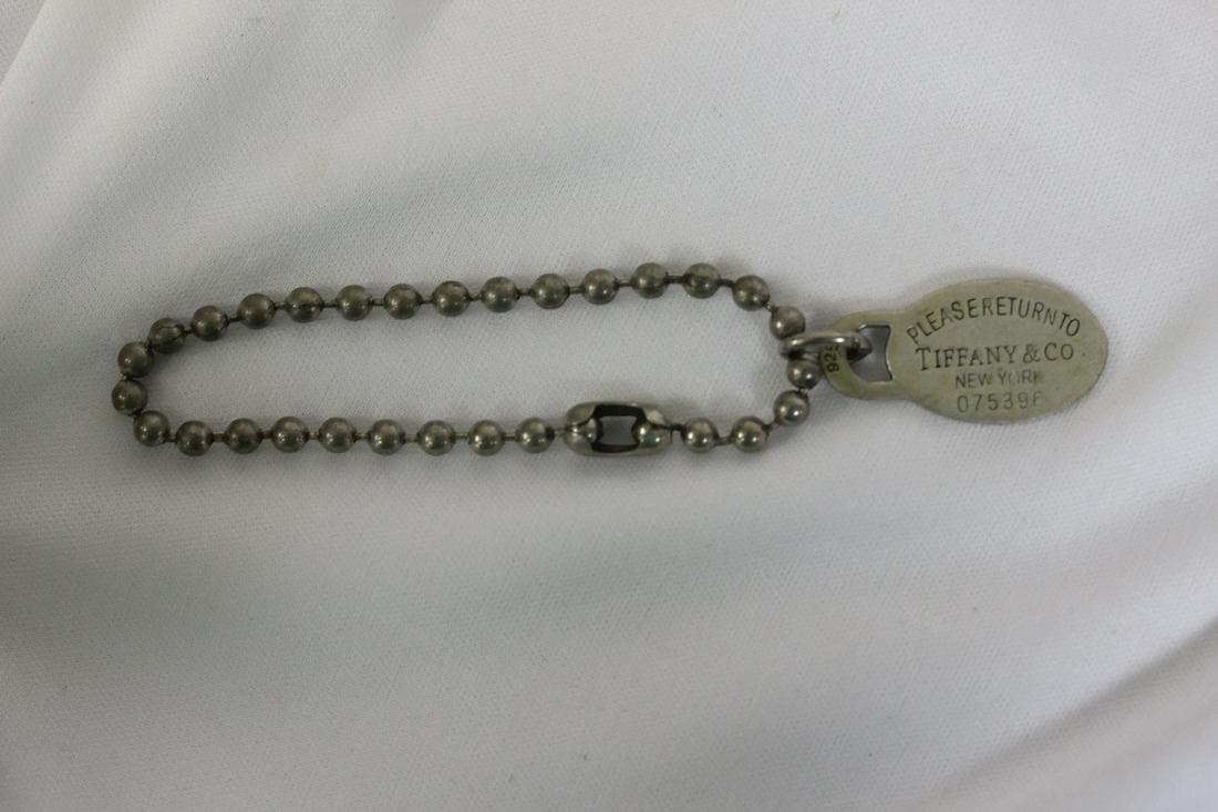 A Marked Tiffany and Company Pendant with Chain: most likely a keychain - marked 925 which means sterling