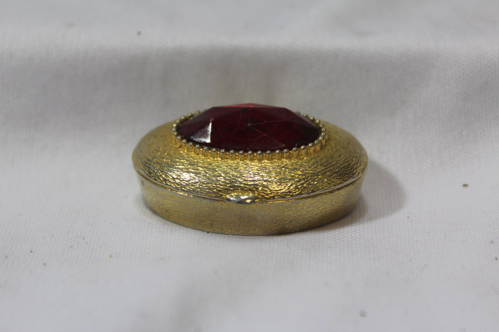 A Stone or Glass Metal Pill box: 1 1/2" across