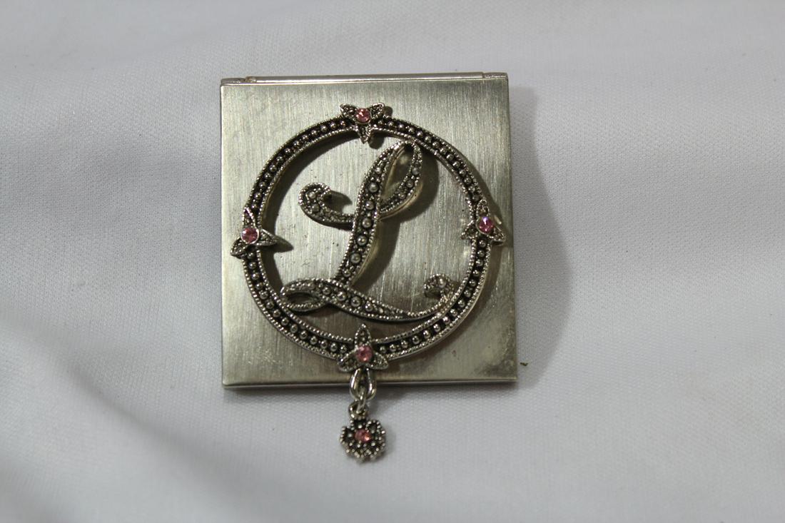 A compact: 1 7/8" square