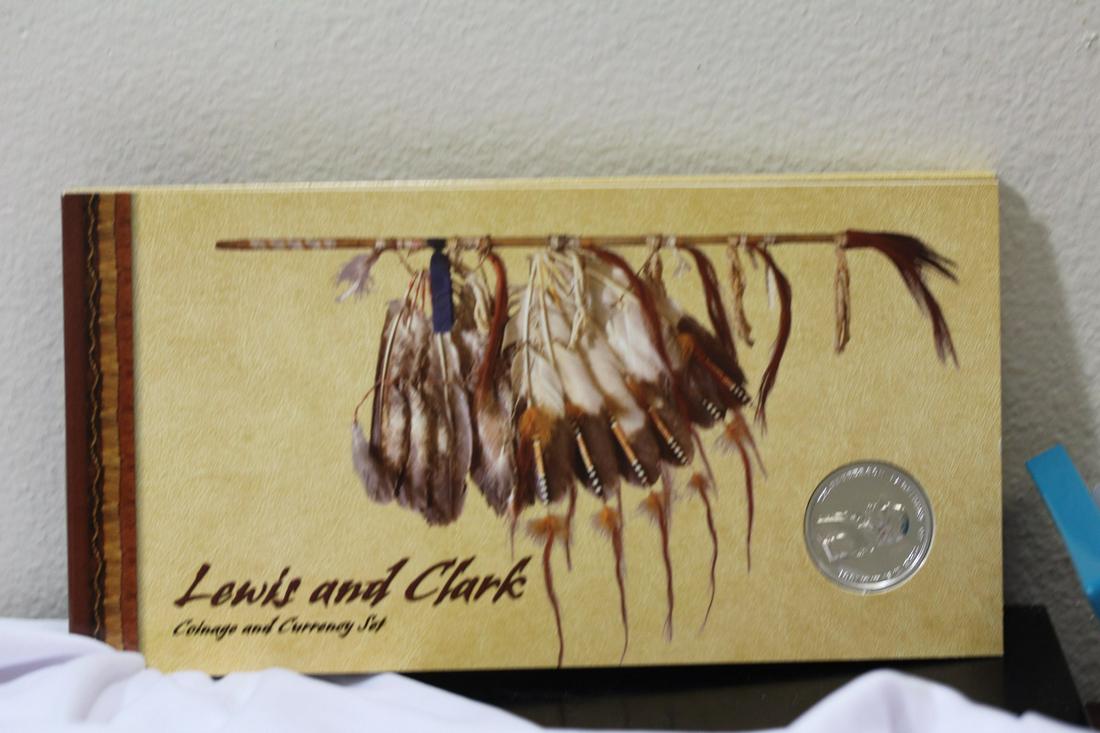 A Lewis and Clark Expedition Coin and Stamp Set: largest coin is silver