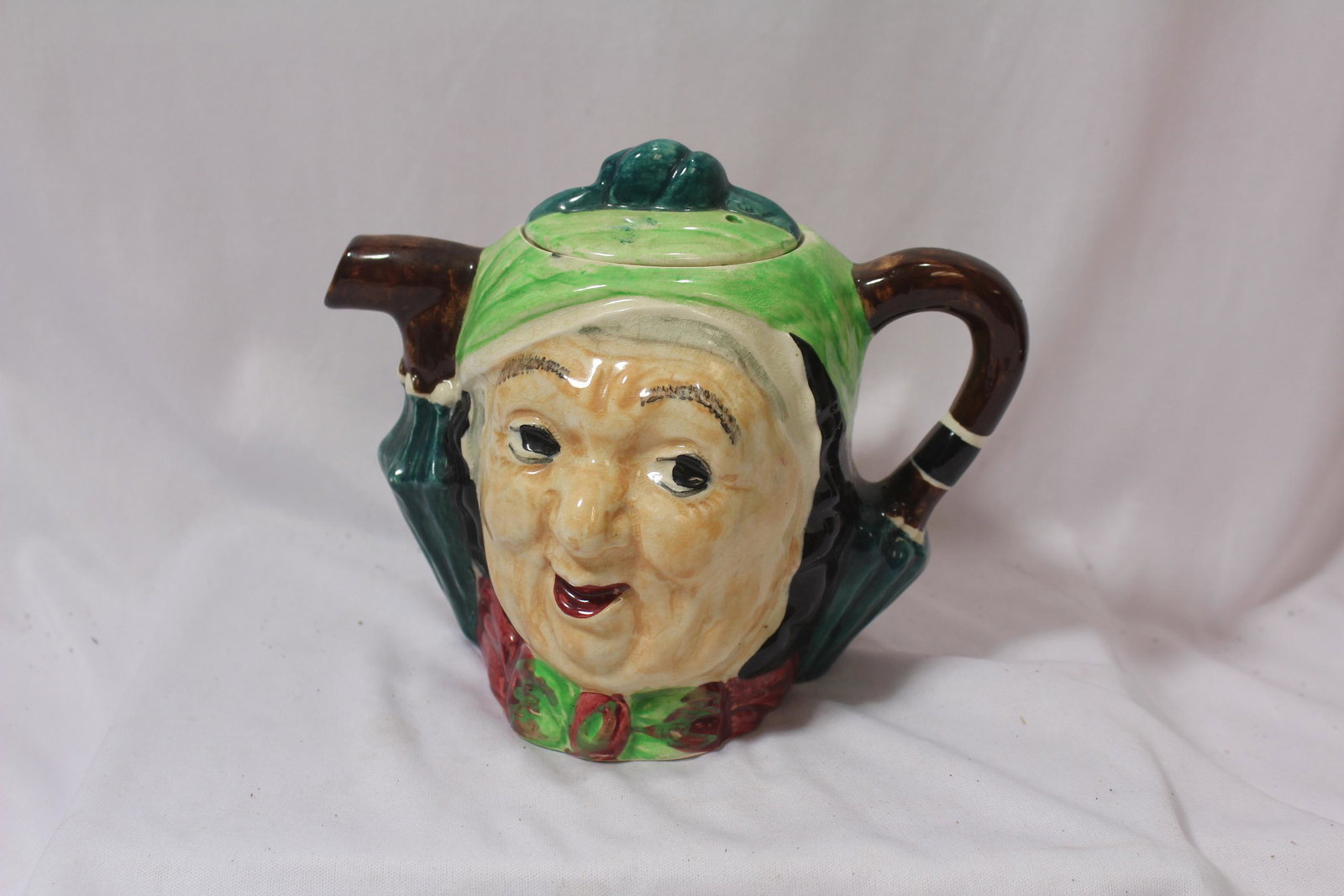 A Lingard Pottery Teapot: Made in England - two face - Sairey Gamp from Dickens' Martin Chuzzlewit - with lid - rare - 6 1/2" tall