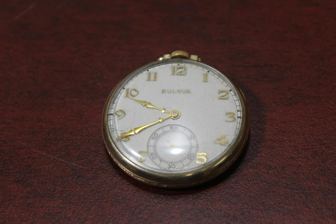 A Bulova Pocket Watch: currently not working - sold as found - 1 3/4" in diameter - most likely art deco period
