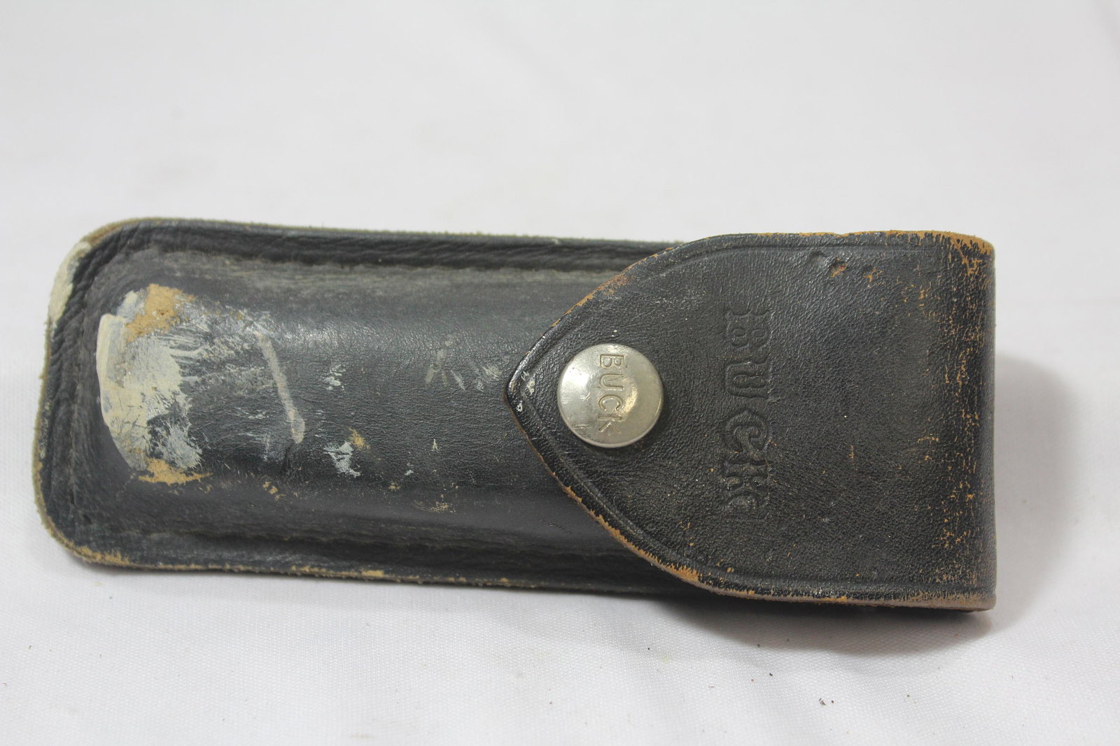 A Buck 110 Knife: with leather sheath - knife= 5" long when folded