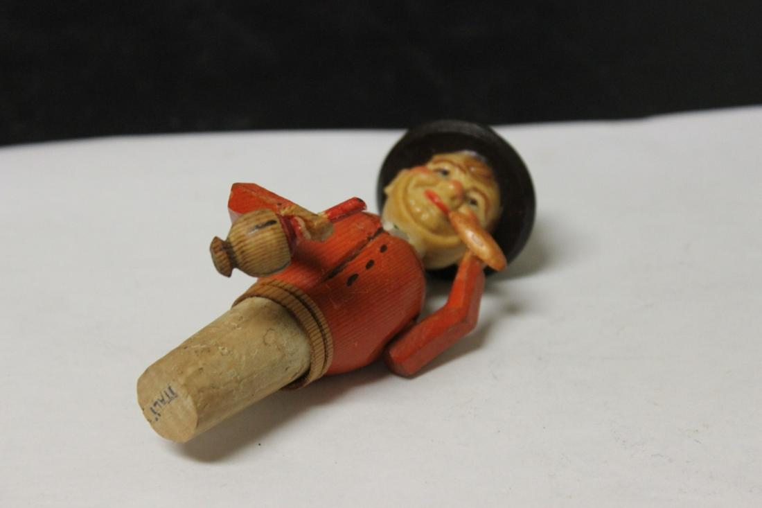 A Wooden Bottle Top with Animated Figure: its articulated - moves when lower the lever - 5" tall