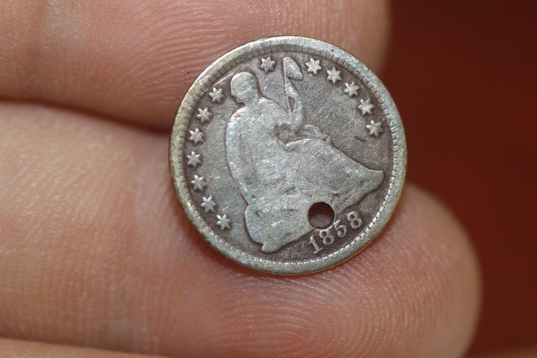 An 1858-O Silver Hald Dime: please note: hole
